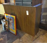 Front view of wood-veneer bar with tapered legs