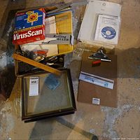 Assorted items including frames, paper cutter, boxed software and rulers