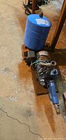 Full view of jet pump assembly with attached gauge, motor, fittings and blue pressure tank