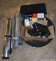 Group shot showing stereo box, spare tire, mats, sunshades, fan and accessories