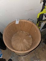 Top view inside first wood bushel basket showing stave construction and metal bands
