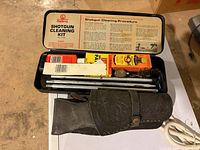 Open Outers tin case showing contents and leather holster