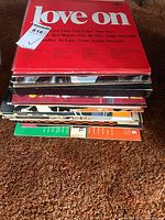 Stack of vinyl LP records showing album jackets