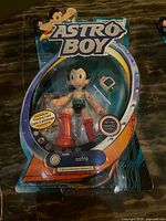 Front view of sealed Astro Boy figure showing packaging artwork and contents