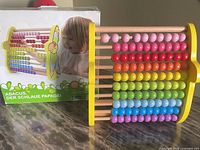 Abacus with retail box showing product details