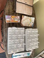 Group shot of all items on table: changing mat, spoons pack, feeder bag kit, two drying racks, bottle brush package