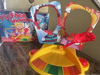 Box and assembled Pie Face Showdown game on table