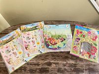 Four sealed character sticker and decoration packs laid out on table