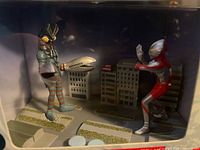 Front view of figures inside box