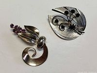 Both brooches front view showing overall design and tone contrast