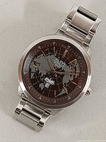 Front view of Alba watch showing world map dial and bracelet