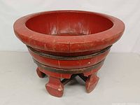 Full view of red lacquered wooden wash basin on stand