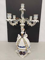 Front view of porcelain five-arm candelabra with female figure
