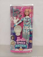 Front of sealed Barbie Space Discovery astronaut doll set showing contents