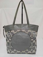 Front view showing signature canvas, round leather panel and leather trim