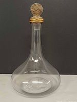 Full view of clear glass decanter with stopper