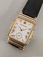 Front view showing rectangular dial, Roman numerals, brand name