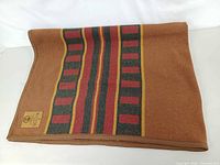 Folded blanket showing overall colour and stripe pattern