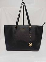 Front view showing overall style, logo, straps, charm