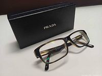 Front view of Prada eyeglasses with case