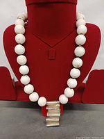 Necklace on display bust showing bead size and pendant