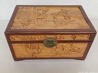 Front and lid showing carved scenes and brass clasp