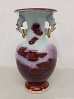 Front view showing flambé glaze pattern and dragon handles with rings