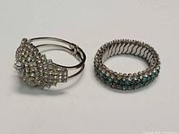 Clamper and stretch bracelets side by side