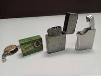 Group shot showing both lighters, razor box, bill case