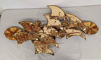 Front view of hammered brass wall sculpture
