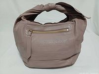 Front view showing zip pocket, embossed logo, overall shape