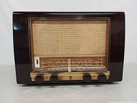 Front view showing grille, dial and knobs