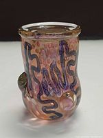 front view showing pink iridescent body, blue ribbon pattern, flared rim