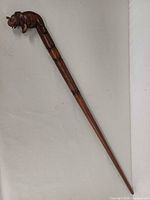 Full view of 38-inch wooden walking stick showing taper and ring bands