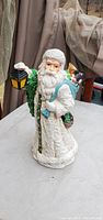 Front view of white ceramic Santa Claus holding lantern