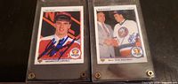 Both 1990-91 Upper Deck Young Guns #1 Draft trading cards in screw-down hard plastic cases with signatures