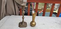 Pair of brass candlesticks and incense on table