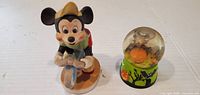 Front view of both Mickey Mouse collectibles