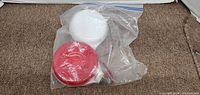 Red and white round trailer lights in clear plastic bag showing wiring