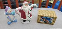 Lot overview showing Santa figurine, snowman figurine, boxed mugs