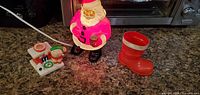 All three items: illuminated Santa blow mold, plug-in elf at chimney figure, red plastic boot