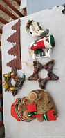 All seven Christmas decor items laid out on table