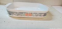 Top angled view of rectangular CorningWare Silk & Roses casserole dish showing pattern band and handles
