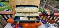 Open tackle box showing interior tray, contents, color and material
