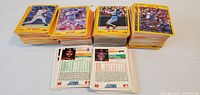 four stacks of Score yellow/tan baseball cards, two cards flipped to show backs