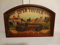 Front view of carved wooden Mercedes SSK sign