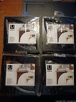 Front of four sealed packages showing Umbra Brace shelf brackets