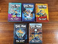 Front covers of five Dog Man hardcovers