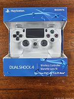 Front of retail box showing white DualShock 4 controller