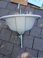 Underside view of Toto sink with faucet assembly attached